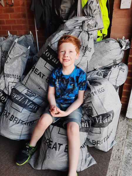 James with a stack of Royal Mail post bags