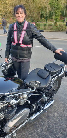 Motorcyclist wearing BTR high vis sash in pink- be safe on your bike