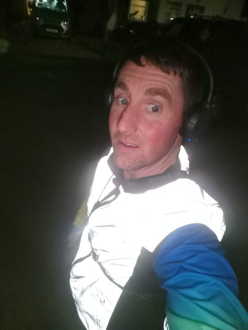 BTR reflective running high visibility gilet being worn by a man demonstrating how high viz it is at night