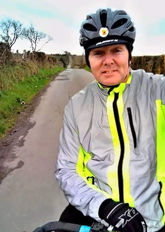 BTR hi viz yellow and reflective silver jacket shown worn on a bike ride - be seen 