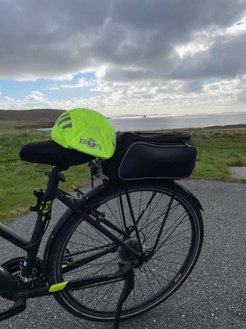 Sheila in Shetland on biking holiday customer photo from BTR Sports of helmet cover and rack bike bag