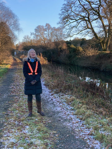 BTR high visibility reflective orange sash and vest worn by a woman